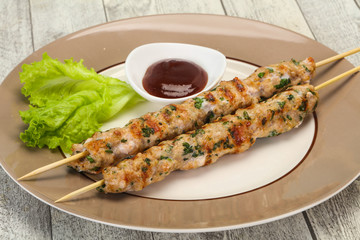 Minced pork skewer kebab with sauce
