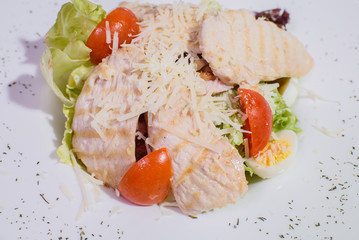 Delicious fresh caesar salad on a large white plate.