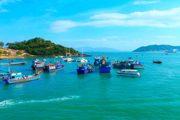 Fototapeta na wymiar Embankment with boats and sailing boats in the city of nha trang in vietnam in February