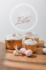 Decorative bunny, chicken eggs, sugar bowl with Easter cakes isolated on grey with happy Easter illustration