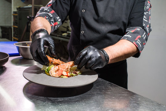 The process of preparing a delicious salad with king prawns. Scampia salad. Seafood.