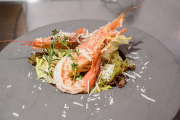 The process of preparing a delicious salad with king prawns. Scampia salad. Seafood.