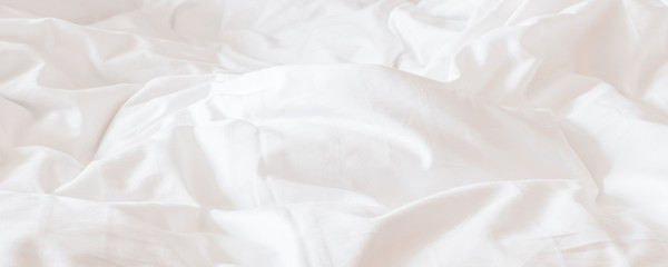 Fototapeta White bed sheet blanket, wrinkled duvet, crumpled comforter cloth used in hotel, resort or home interior for bedding background and sleep comfort obraz