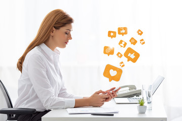 Side view of businesswoman using smartphone near documents and laptop on table, social media illustration