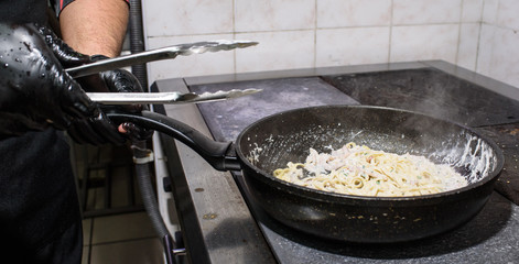 The process of making carbonara pasta for restaurant guests. Tasty food.
