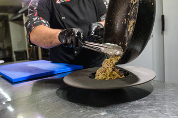 The process of making carbonara pasta for restaurant guests. Tasty food.