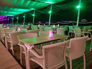 Ibizan nightlife club with tables and lights on the deserted evening sea