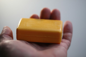 Female hands peeling large yellow ripe mango fruit