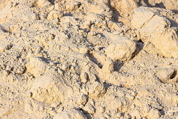 A mountain of white sand to create a beach close up .