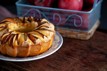 Round apple pie. Homemade pastries. Cupcake with apples on a wooden table. Simple food.