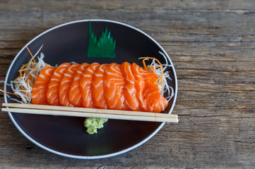 Sliced ​​salmon fillets on a plate on wood Ready to eat
