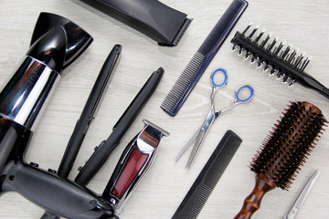 Background of hair cutting tools. Full frame of professional hair styling tools on a wooden background