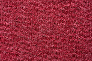 Closeup red texture of woolen knitted fabric. Pattern of red fabric.