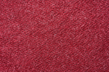 Closeup red texture of woolen knitted fabric. Pattern of red fabric.