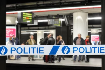 Gordijnen Politie / police tape in front of commuters waiting for train at platform of Belgian railway station in Belgium © Philippe
