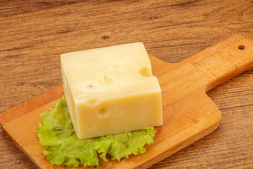 Emmental cheese over wooden board