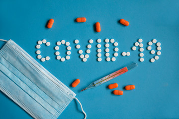 Coronavirus COVID-19 laid out from tablets on a blue background.