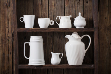 white kitchen dishware on old dark wooden background