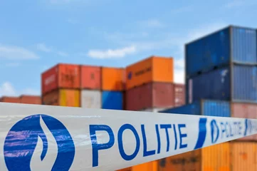 Schilderijen op glas War on drugs. Politie / police tape in front of stacked containers waiting for transport on the quay at Belgian port / harbour in Belgium © Philippe