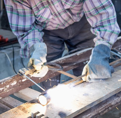 Work in the industry. A man works with a welding machine