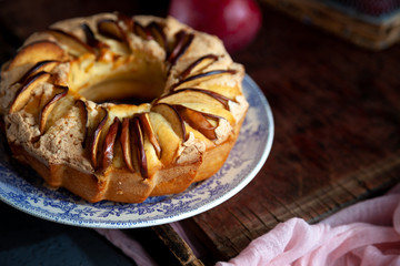 Round apple pie. Homemade pastries. Cupcake with apples on a wooden table. Simple food.