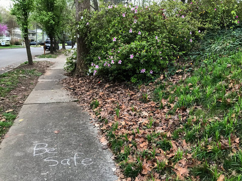 An Encouraging Message Of Be Safe On The Sidewalk Of A Deserted Neighborhood During The COVID-19 Pandemic