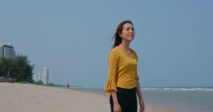 Woman at the beach, breeze with smile