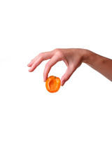 Female hand with tasty apricot on white background