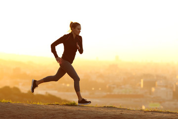 Jogger running at sunset in city outskirts