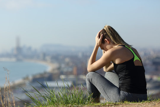 Frustrated Runner Sitting Outdoors Complaining