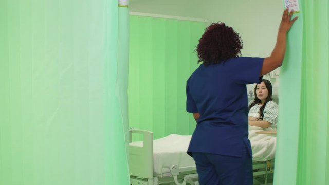 Female Nurse Opens Hospital Curtain