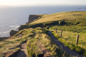 Coastline pathway Cliffs of Moher by sunset