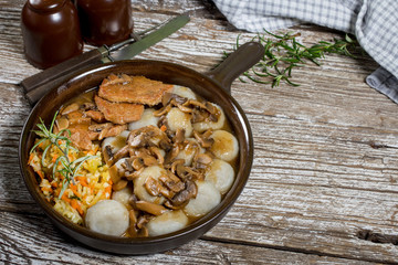 Stewed pork chop in a bright mushroom sauce.
