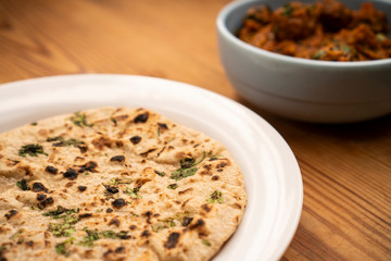 Potato curry with chapatti (roti) placed on wooden table. stock photo