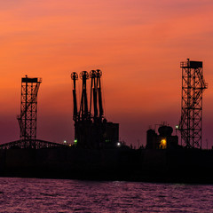 silhouette of oil rig at sunset