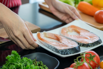 Closeup raw fresh salmon fish steaks with fresh vegetable.