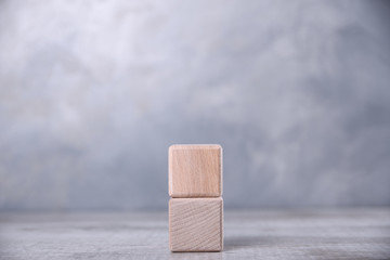 One blank wooden cube with space for your word, letter, symbol on the table. Place for text, free copy space