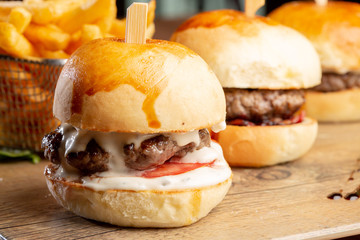 close up of fresh tasty mini burgers and potatoes - obrazy, fototapety, plakaty