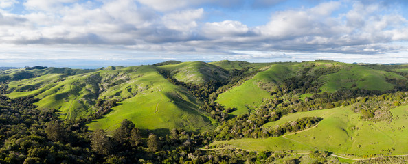 Clouds drift above the bucolic hillside scenery in the East Bay of Northern California. This beautiful region is green in the winter and golden in the summer due to seasonal rainfall patterns.