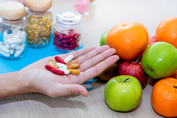 Close up images of nutritionists are showed Vitamine pills, Whichis extracted from various fruits To be and alternative and Strengthen immunity against the coronavirus to health concept.