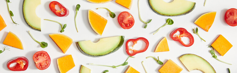 Flat lay with microgreens, cut vegetables and avocado slices on white background, panoramic shot