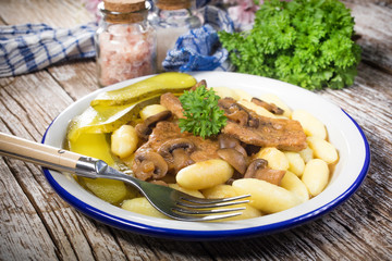 Braised pork loin with mushrooms.