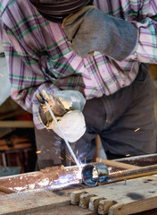 Work in the industry. A man works with a welding machine