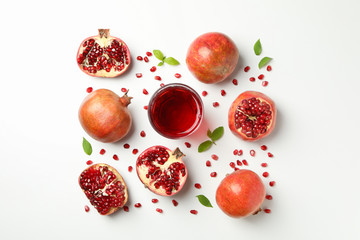 Flat lay with pomegranate, juice and seeds on white background
