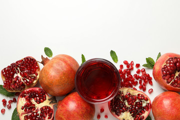 Pomegranate, juice and seeds on white background, top view