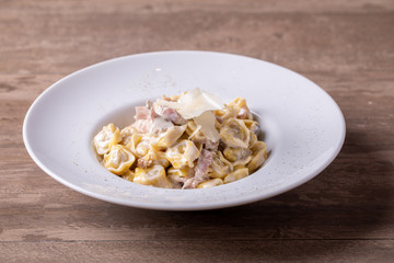 details of fresh, hot tortellini carbonara, with parmesan