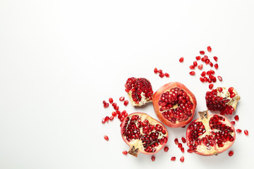 Pomegranate and seeds on white background, space for text