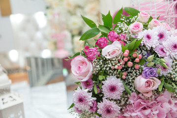 Beautiful bouquet of colored roses wrap bulurred background . Multi-colored flower bouquet .