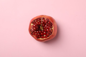Pomegranate on pink background, top view. Juicy fruit