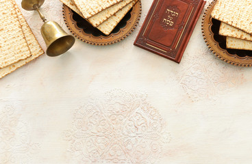Fototapeta na wymiar Pesah celebration concept (jewish Passover holiday). Traditional book with text in hebrew: Passover Haggadah (Passover Tale)